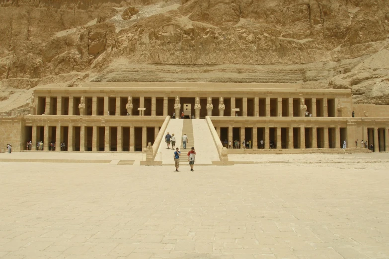 two people in front of an obelisk that is stone