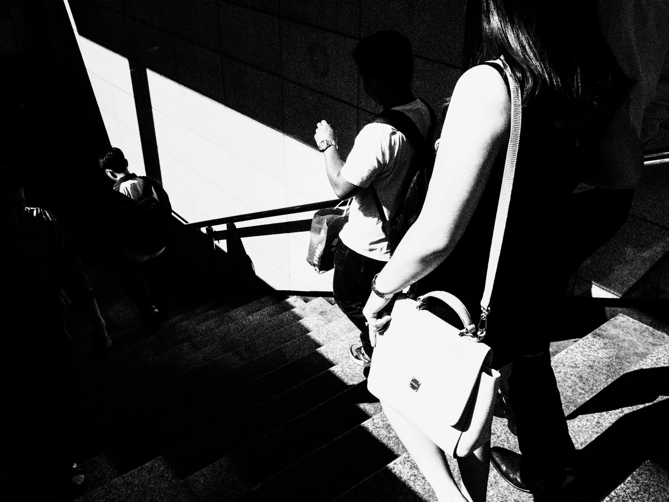 a woman holding a suitcase sits on a plane