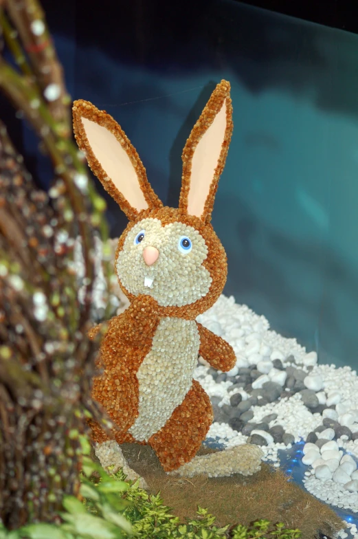 the fabric stuffed rabbit is on display in the aquarium