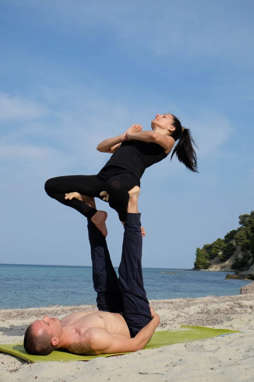 a couple of people on top of a yoga mat