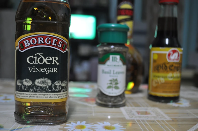 bottles of cider vinegar and honey sitting on a table