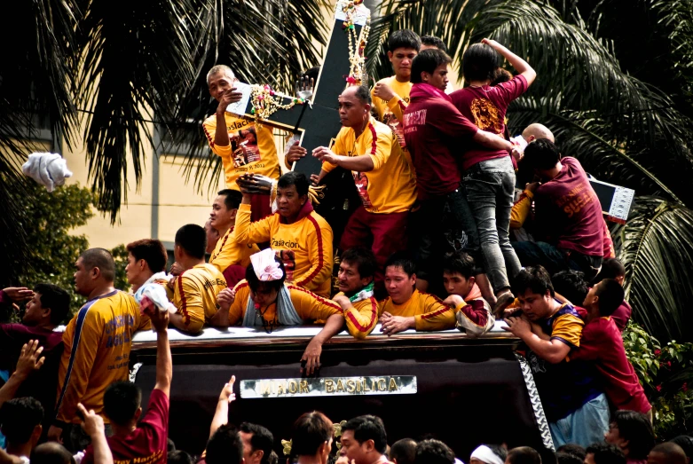 a crowd of people riding on top of a truck