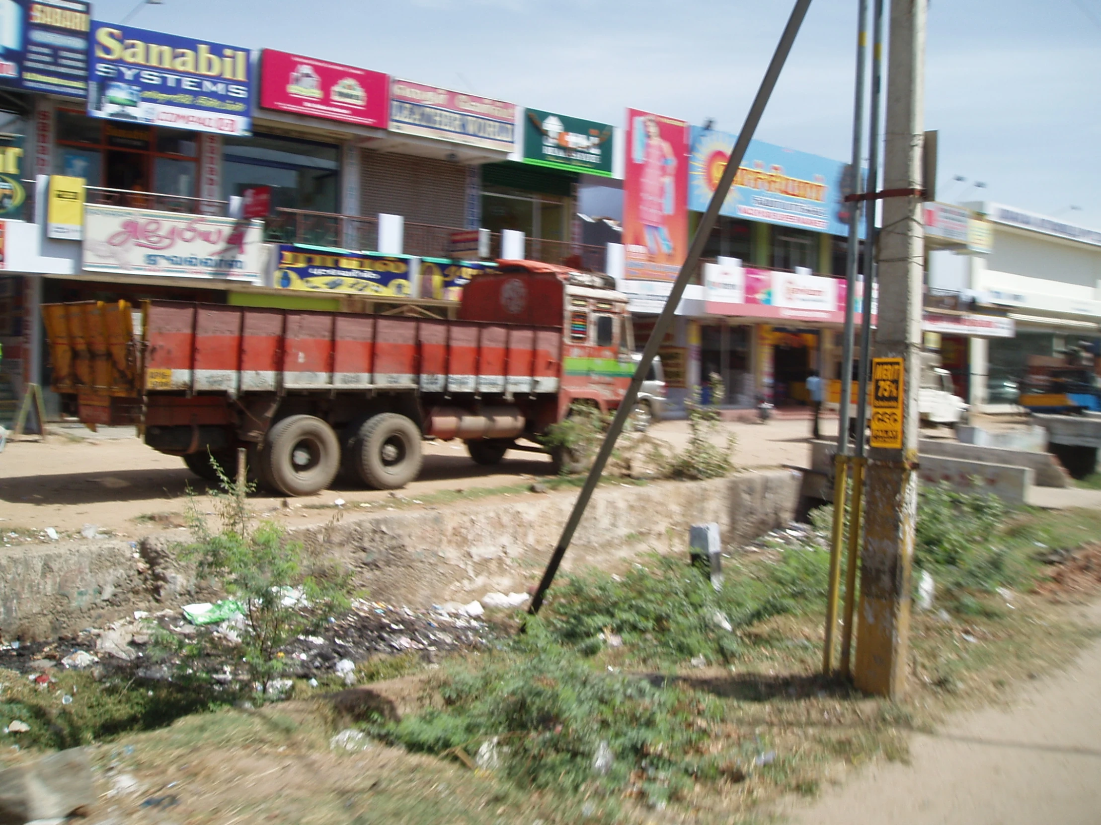 a dirty truck that is in front of a store