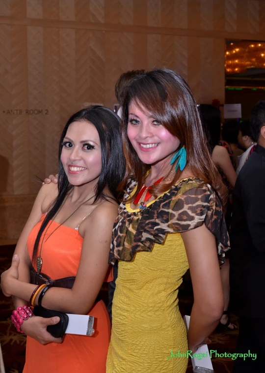 two ladies standing together smiling at a party