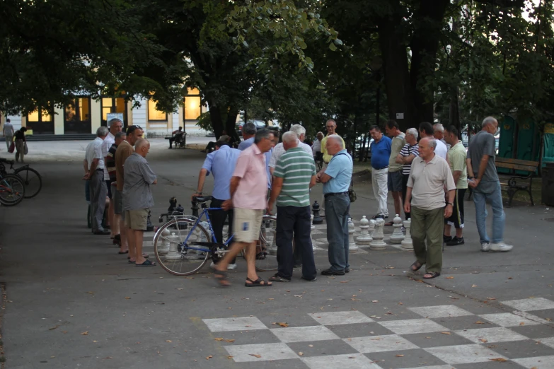there are many people standing together in the street