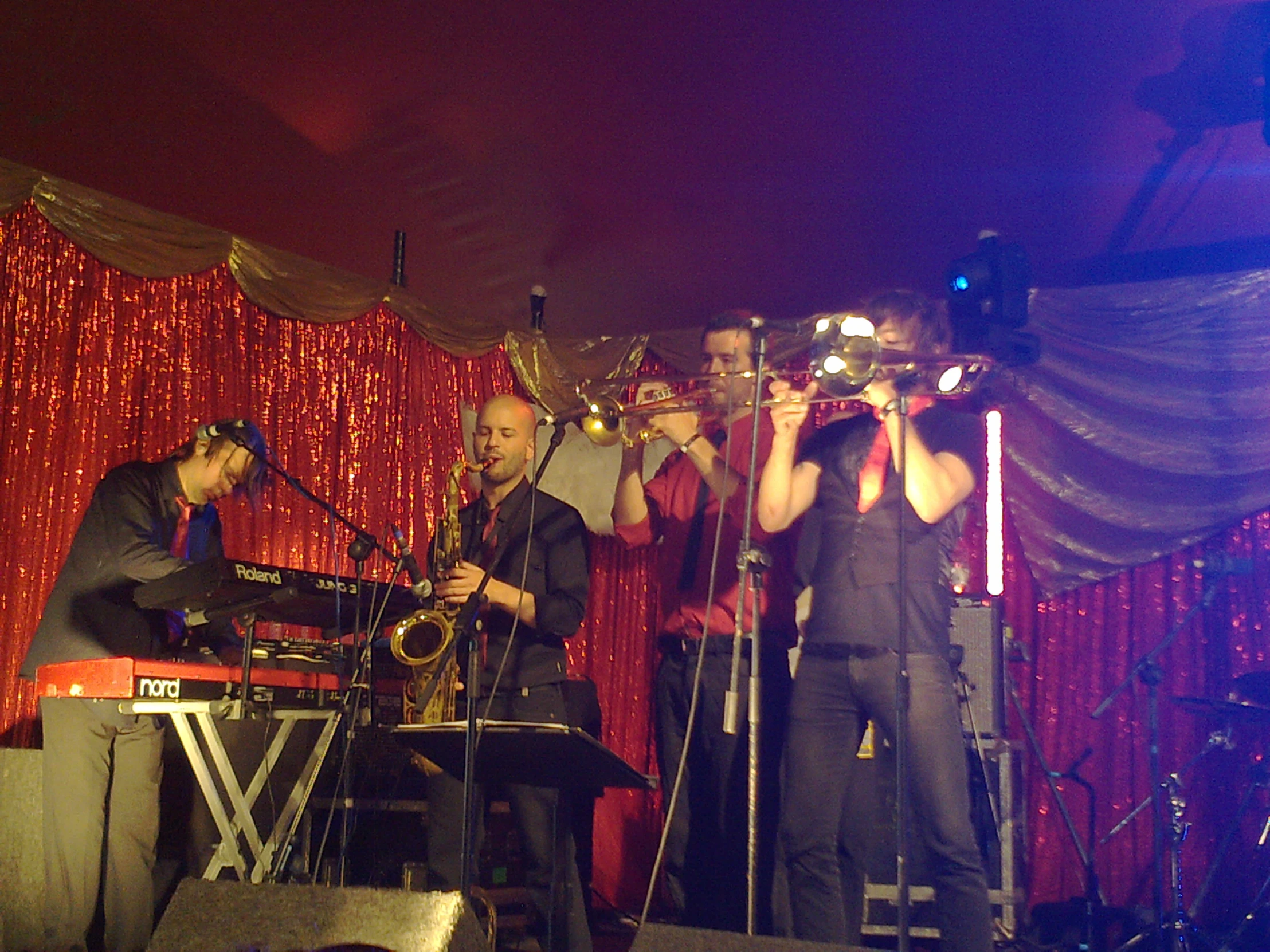 a band performing on stage at a night club