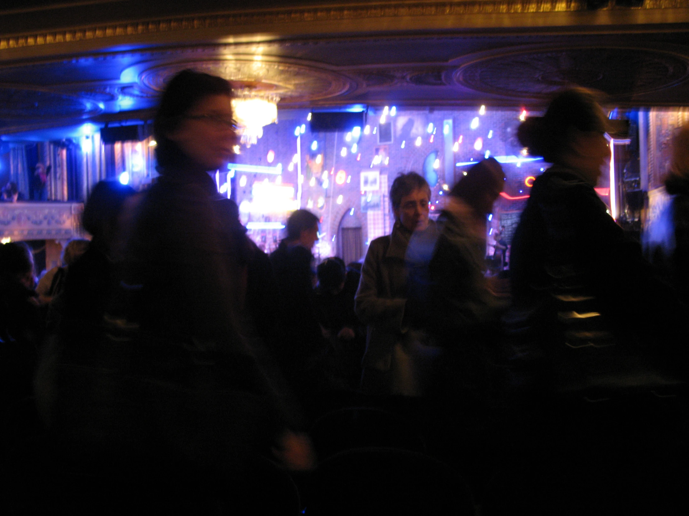 a group of people standing around at a bar