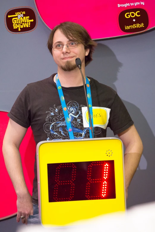 a man is standing in front of a large clock