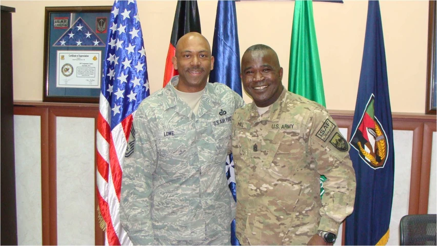 two people standing next to each other in front of flags