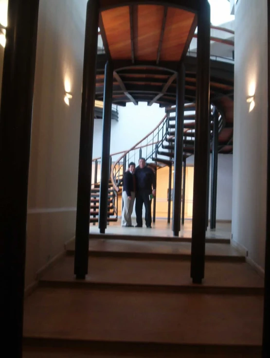 two men are in the doorway of a large staircase