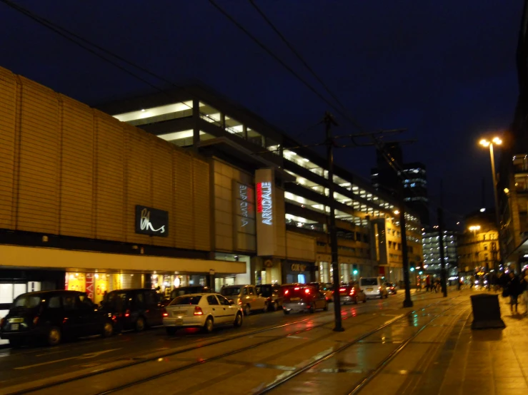 a city street filled with lots of traffic at night