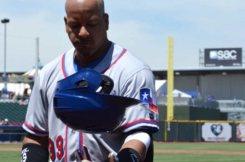 a baseball player with his helmet on and glove in one hand