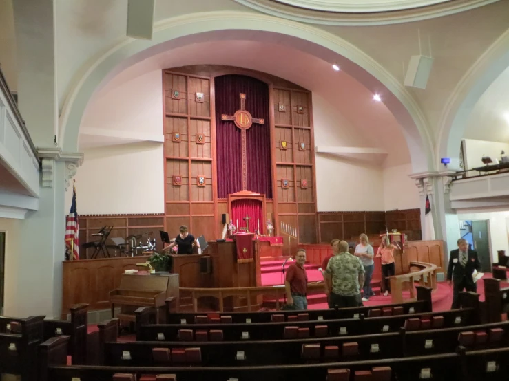 people are standing in the navel of a church