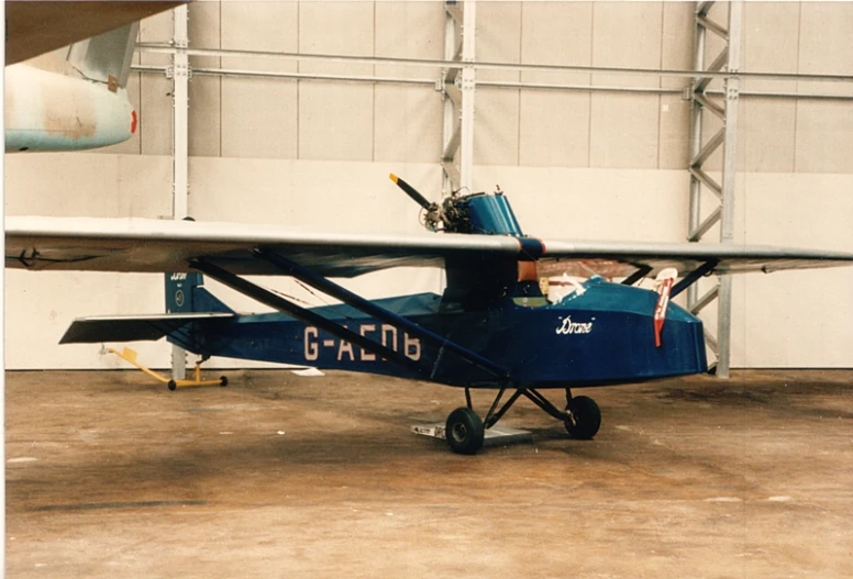 the airplane is in the hanger at the airport