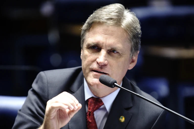 a man in a suit talking at a podium