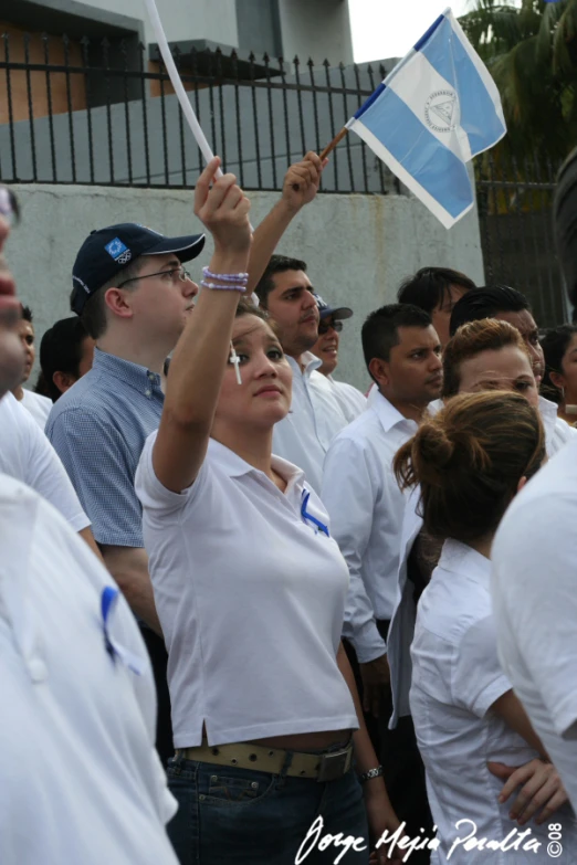 a group of people holding up flags in front of a building