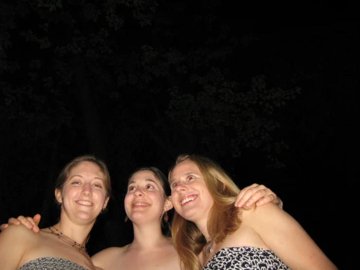 three women taking a selfie together under a tree