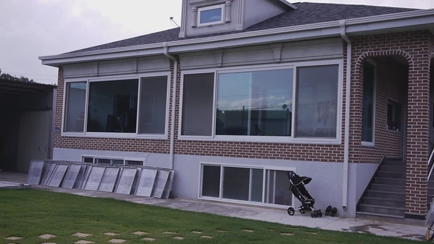 a person's stroller standing near some windows in a house