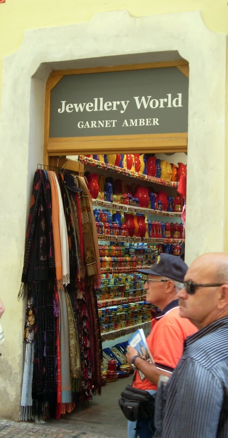 people looking in a shop for scarves and hats