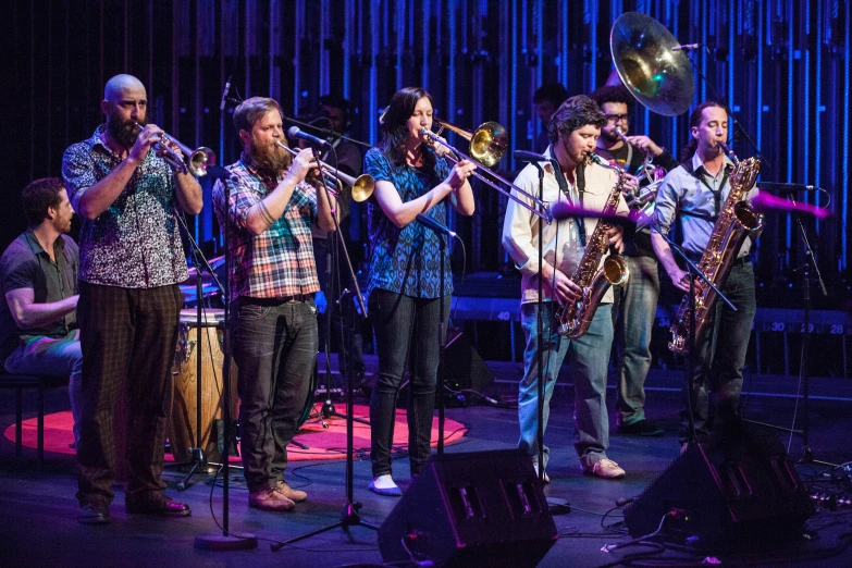 the band is singing into their instruments at night