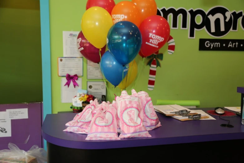 there are balloons and a cake on the table