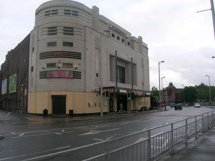 an old rundown theater on the corner of a street