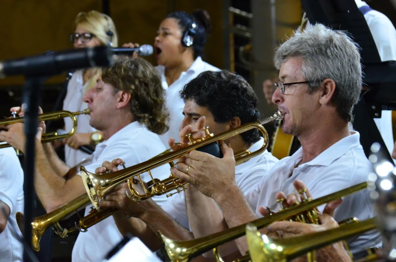 a group of men and women playing instruments in a band