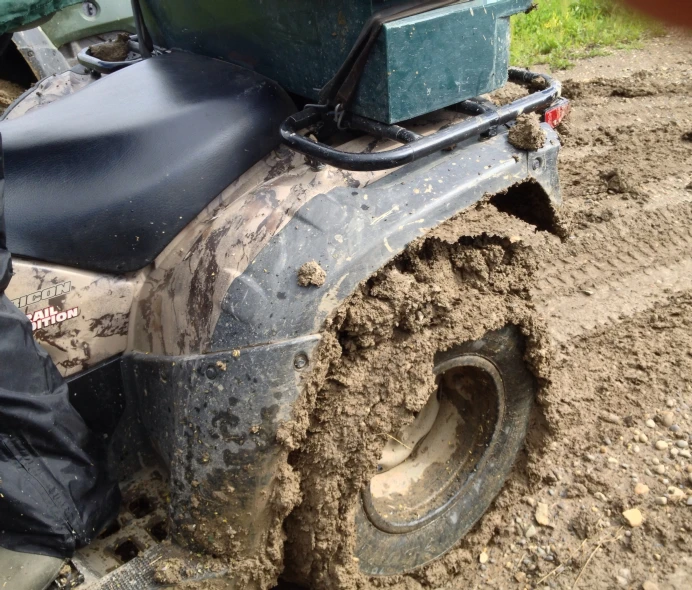 a vehicle with a back load riding in the mud