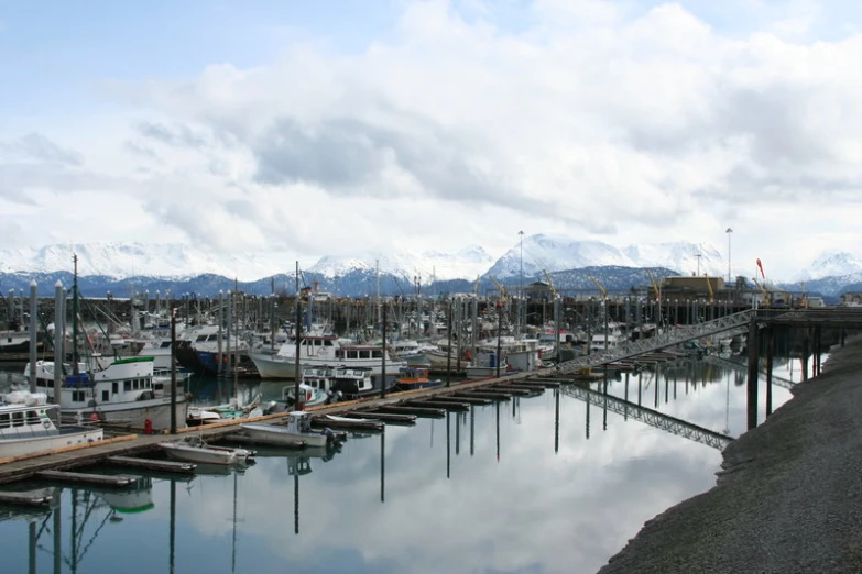 a harbor filled with lots of boats under a cloudy sky