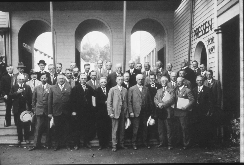 a group of men are standing outside of a building