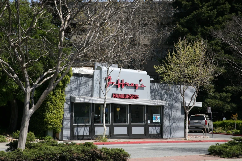 a tall gray building sitting on the side of a road