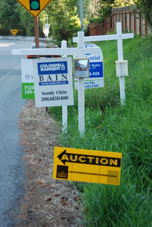 this is a white fence with signs attached to it