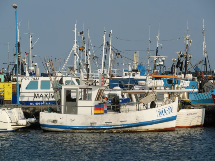 several boats docked and some of them being used as fishing vessels