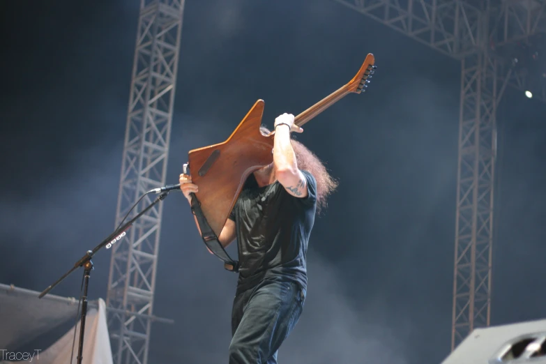 a man with a very large guitar case on stage