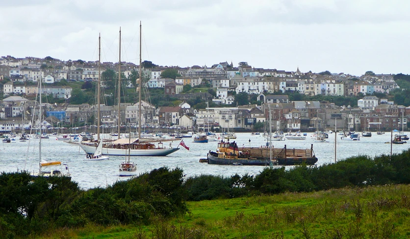 boats floating in a body of water near a hillside