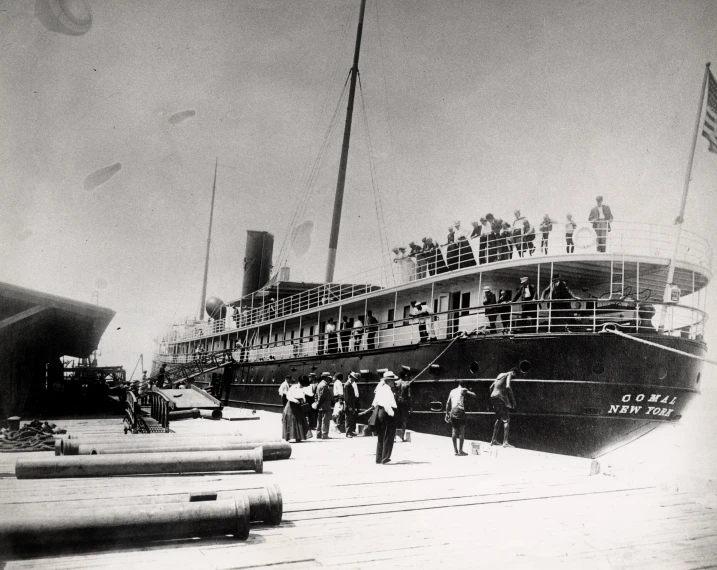 many people are gathered at the deck of a large boat