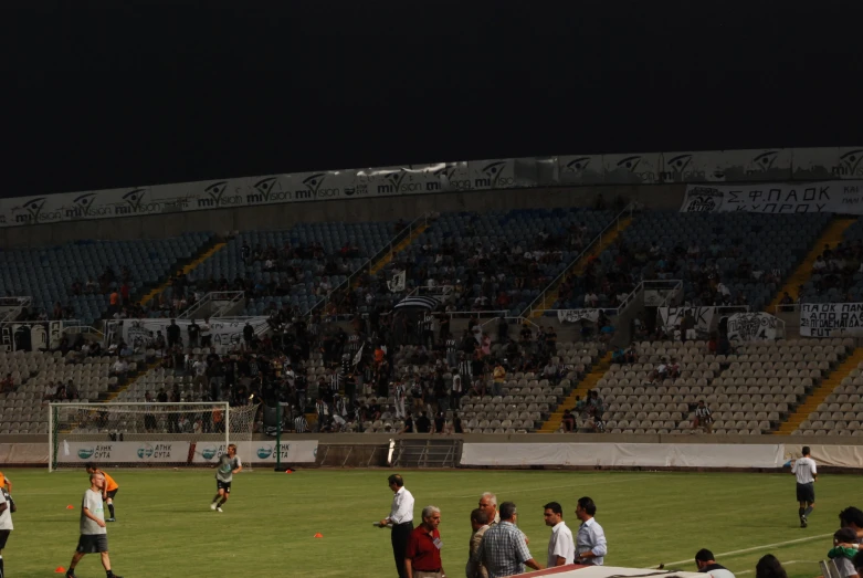 several men playing soccer at an empty stadium