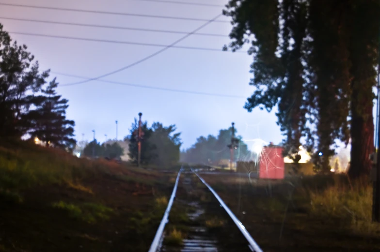 some tracks near a city street at sunset