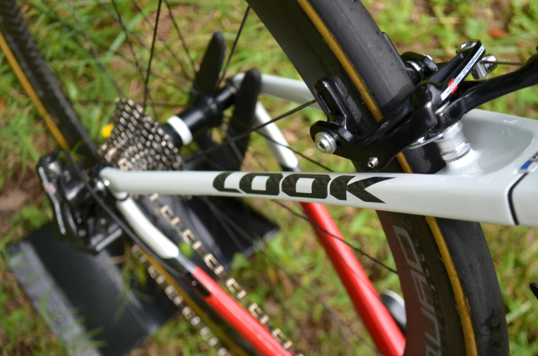 the rear ke of a bike with some green grass and grass