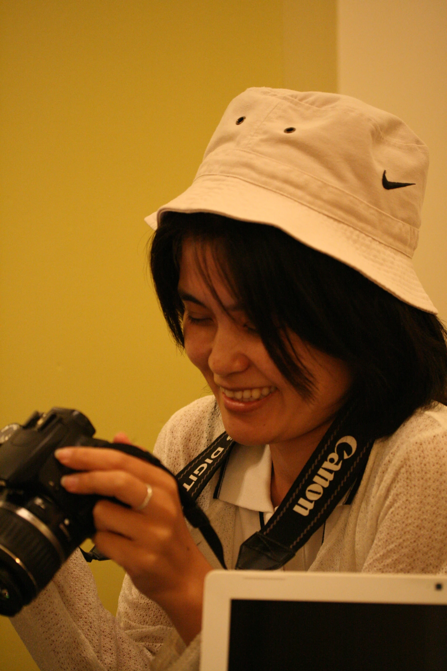 a smiling woman with a camera attached to her shoulder