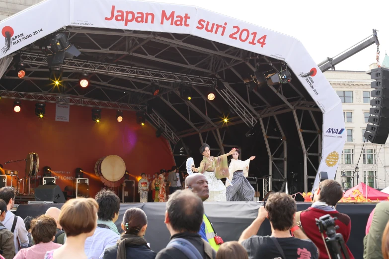 group of people on a stage at a festival