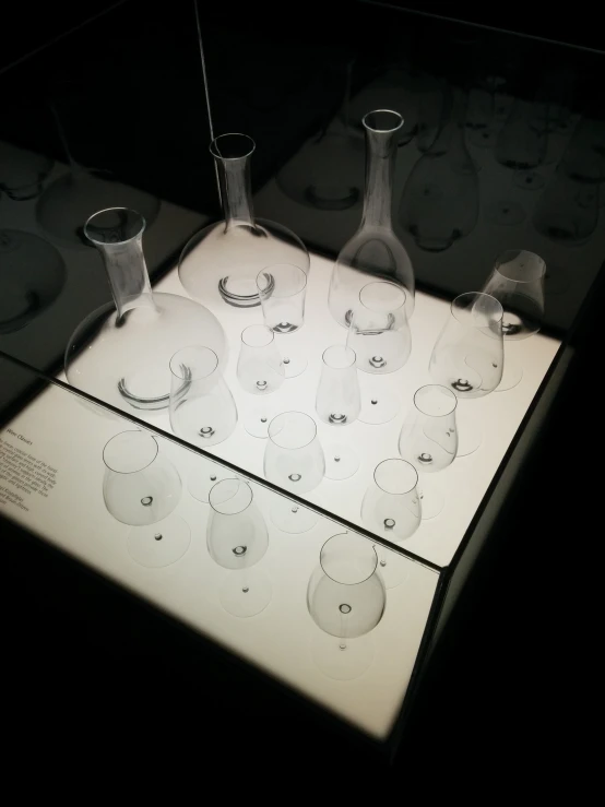 an assortment of glasses sitting on display behind a glass