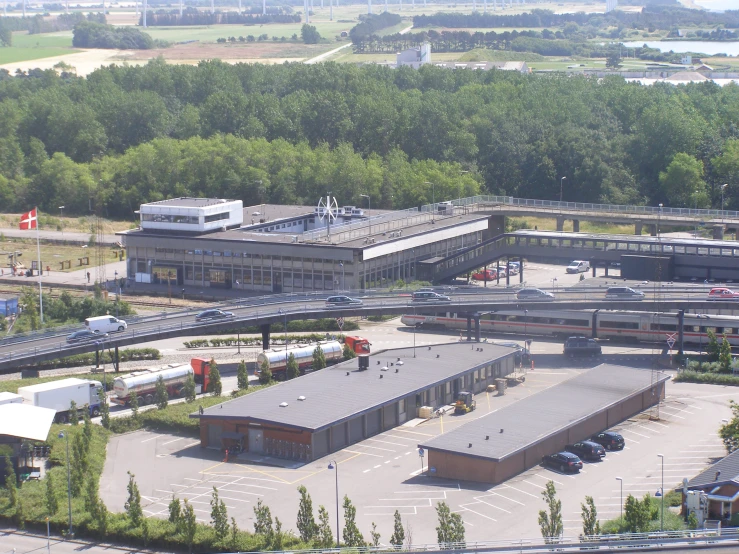 a train depot with a parking lot in front of it