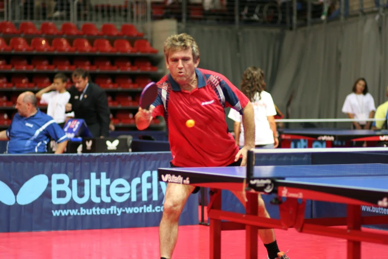 a man is playing tennis with a racket and ball