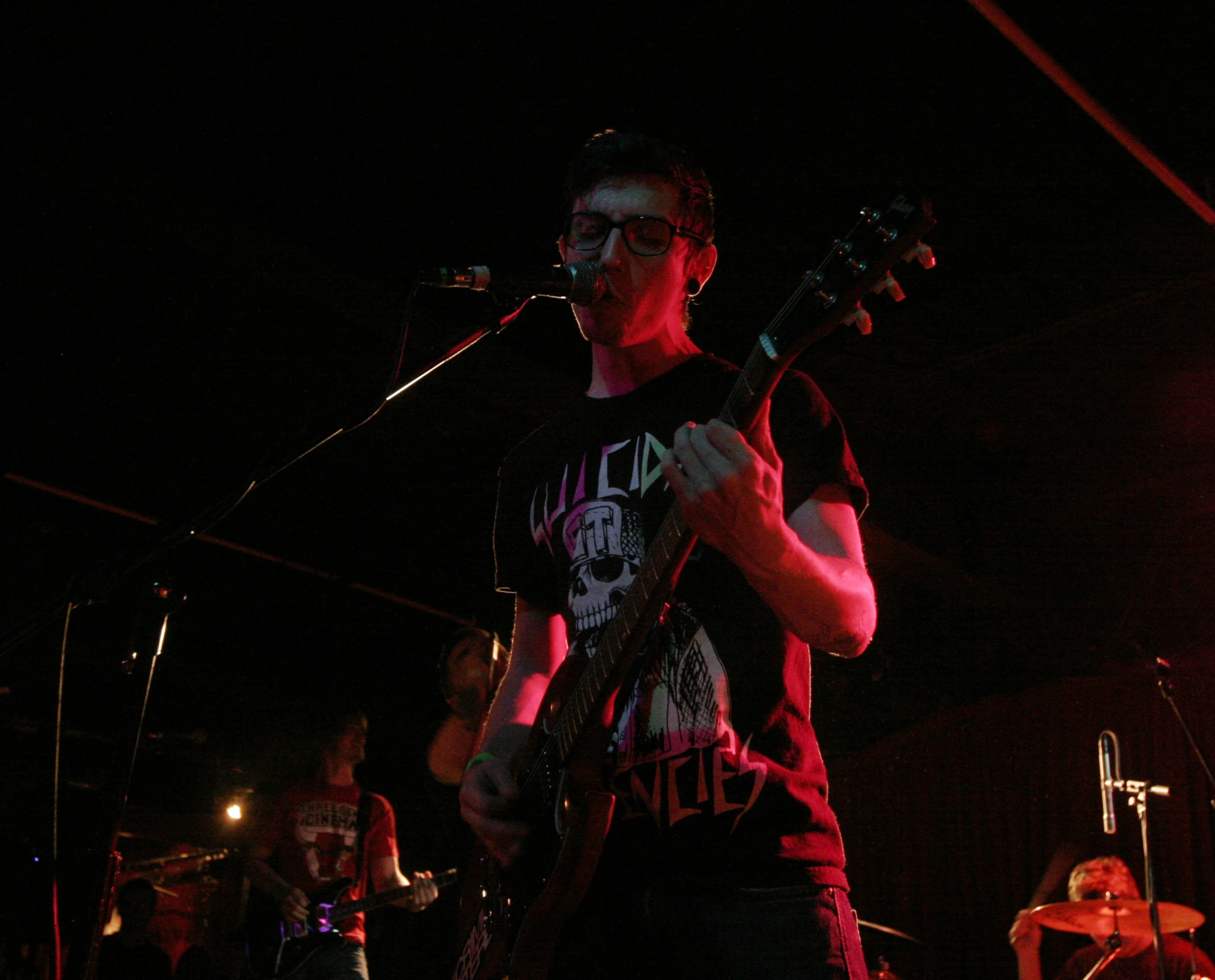 young musician performing on stage in dark