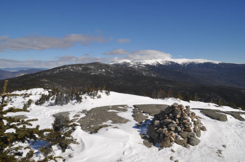 a snow covered mountain with hills in the background