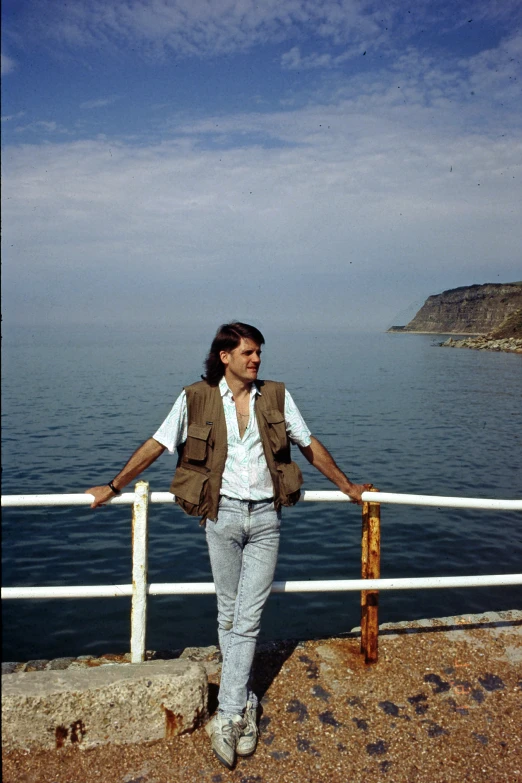 a person by the water posing for a picture