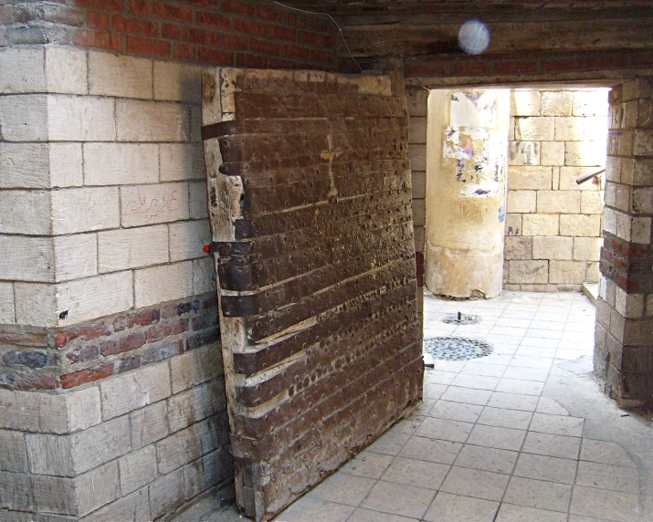 a brick door is open in a hallway of brick house