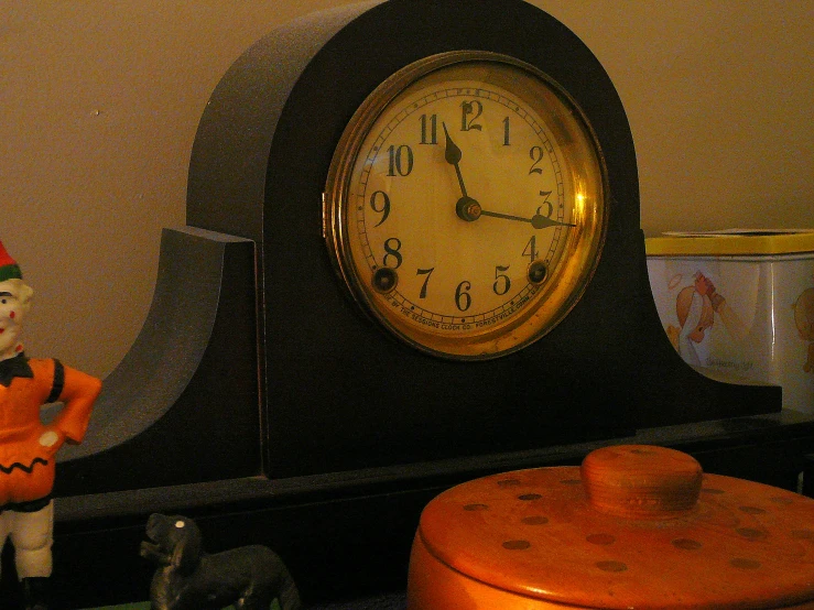 a clock that is on top of a shelf