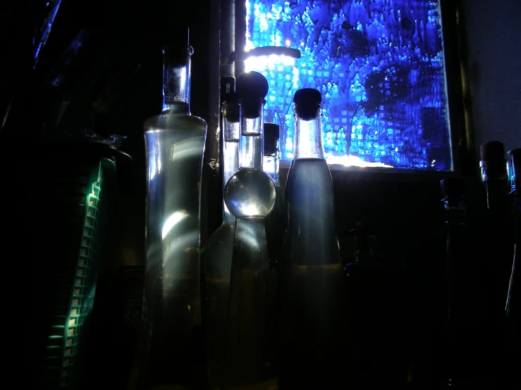 a table topped with bottles and spoons sitting next to a blue tv